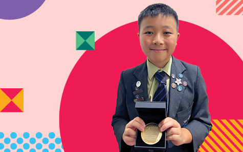 student holding icas competition medal
