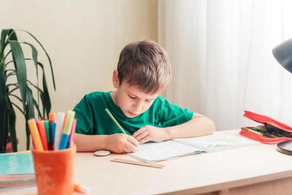 boy practising for icas writing