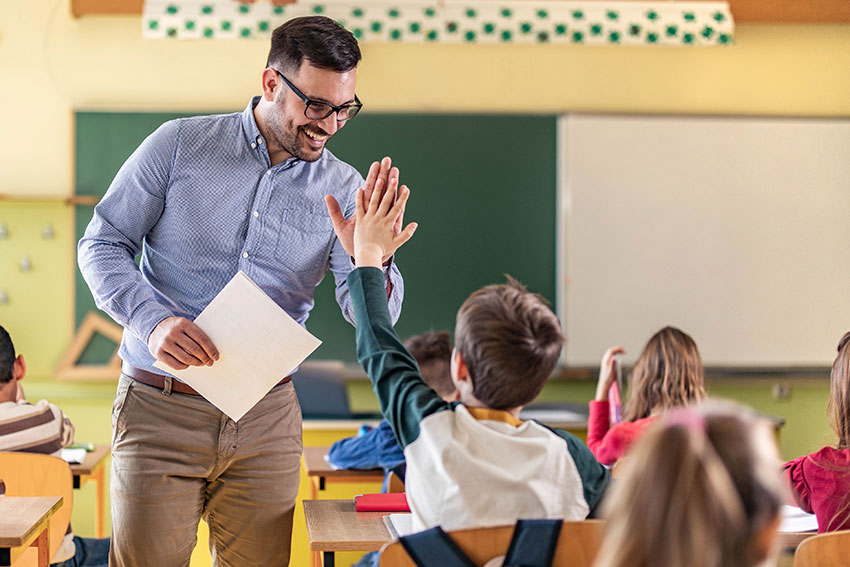 male teacher high-fiving during formative assessment