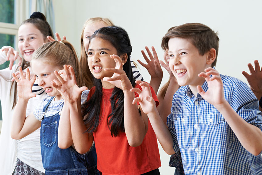 students pulling scary faces drama