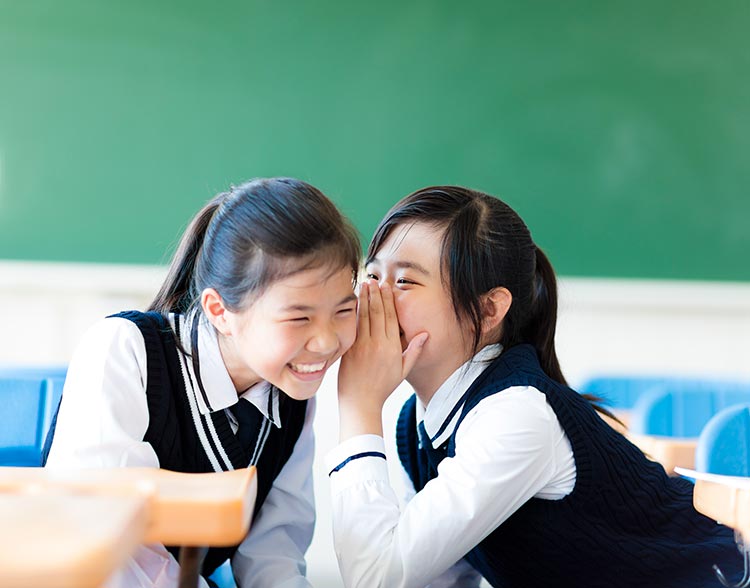 students speaking / whispering to each other
